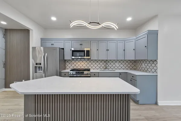 a kitchen with a stove a sink and a refrigerator