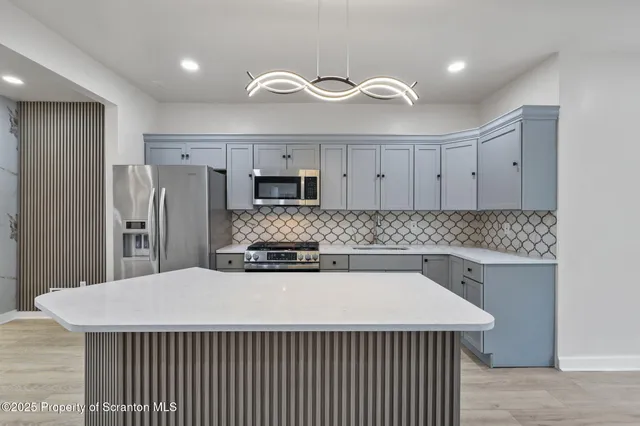 a kitchen with a stove a sink and a refrigerator