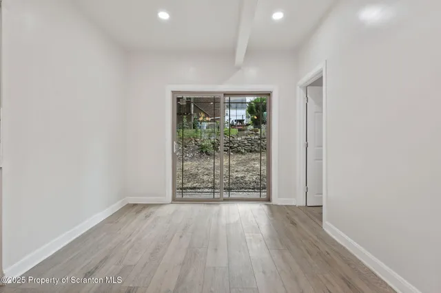 wooden floor in an empty room with a window