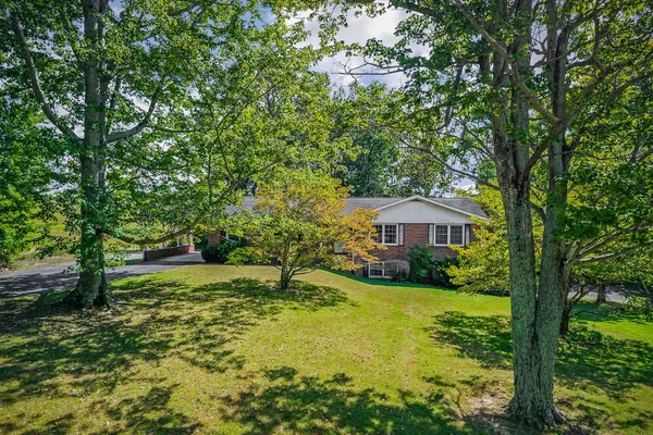 a view of a garden with a house in the background