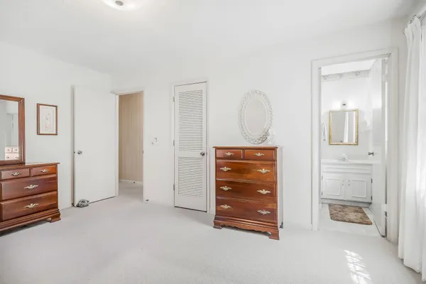 an empty room with closet and mirror