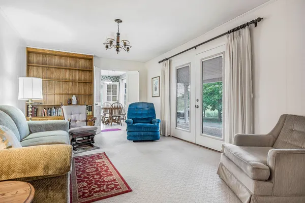 a living room with furniture and a chandelier