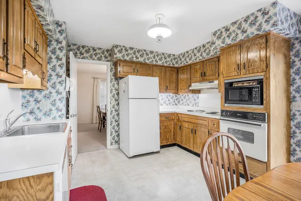 a bedroom with a bed and a refrigerator