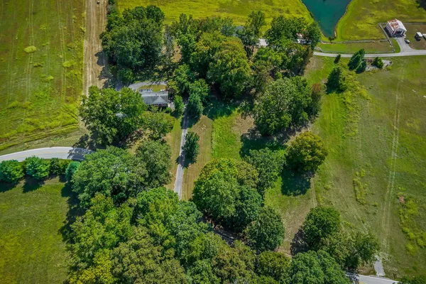 an aerial view of a houses with a yard