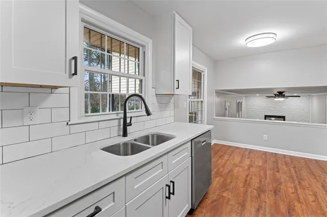 a kitchen with stainless steel appliances a refrigerator sink and microwave