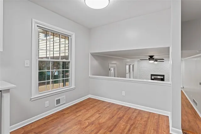 an empty room with windows fireplace and windows