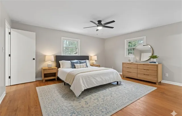 a kitchen with stainless steel appliances a sink dishwasher a refrigerator and a stove with wooden floors