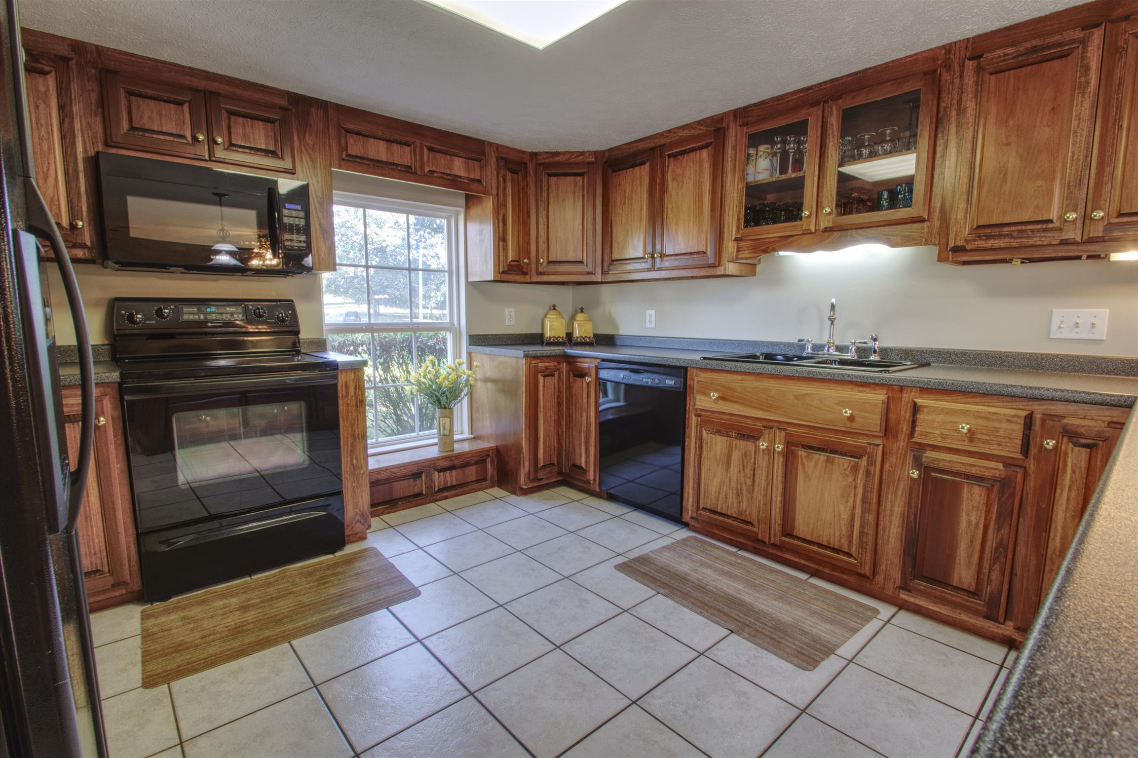 7177 Hall Road Greenbrier, TN 37073 - Photo 27 of 30 a kitchen with granite countertop a stove top oven microwave and cabinets