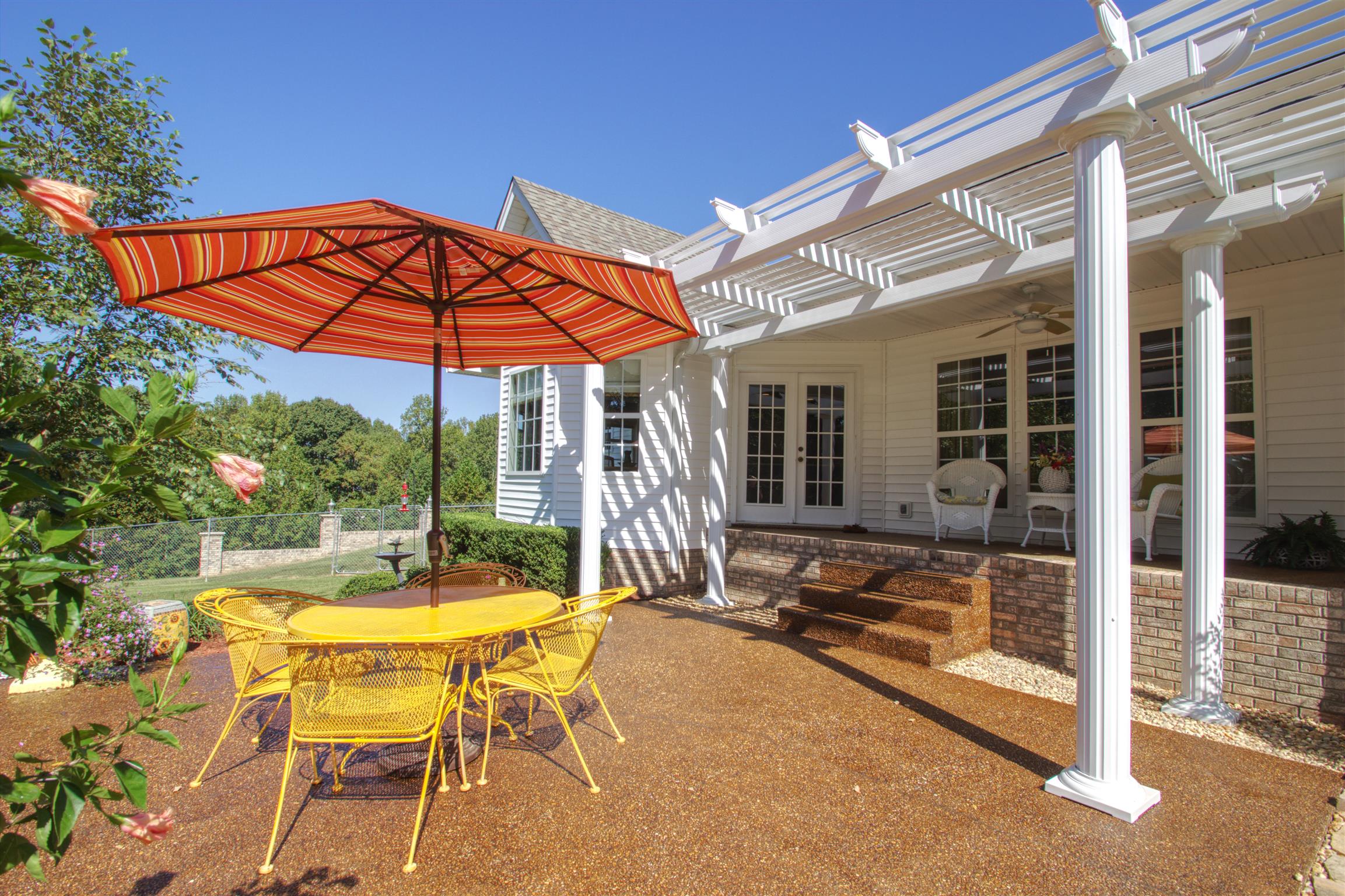 7177 Hall Road Greenbrier, TN 37073 - Photo 3 of 30 a view of a patio with a table and chairs under an umbrella