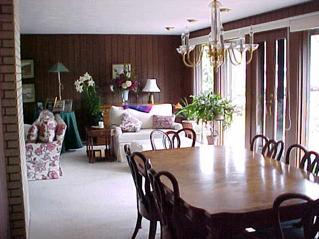 3303 Brookview Road Rockford, IL 61107 - Photo 4 of 6 a dining room with furniture potted plants and wooden floor