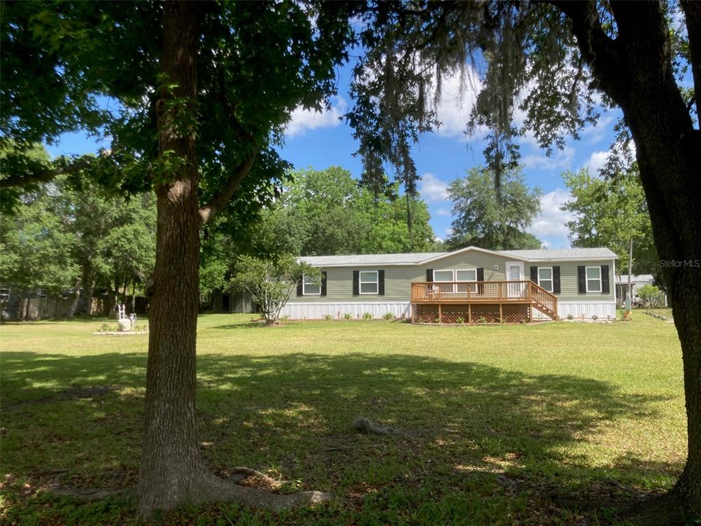 18137 Hollister Road Orlando, FL 32820 - Photo 21 of 27 a front view of a house with garden