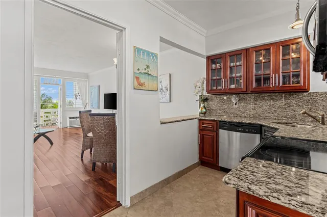 a kitchen with stainless steel appliances granite countertop a stove microwave and refrigerator