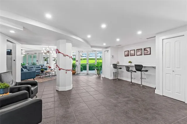 a living room with furniture a chandelier and a rug