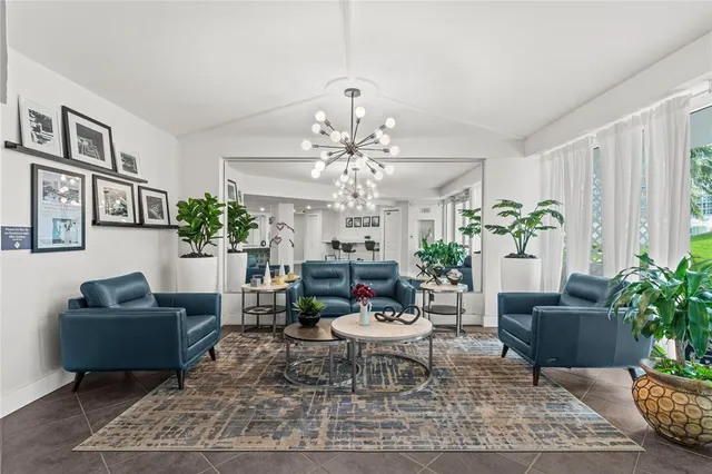 a view of a hallway with wooden floor and a bathroom