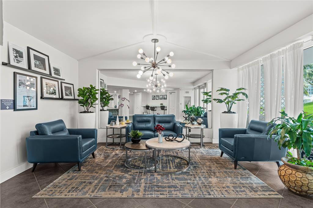 1900 South Ocean Drive, Unit 503 Fort Lauderdale, FL 33316 - Photo 10 of 33 a living room with furniture a chandelier and a rug