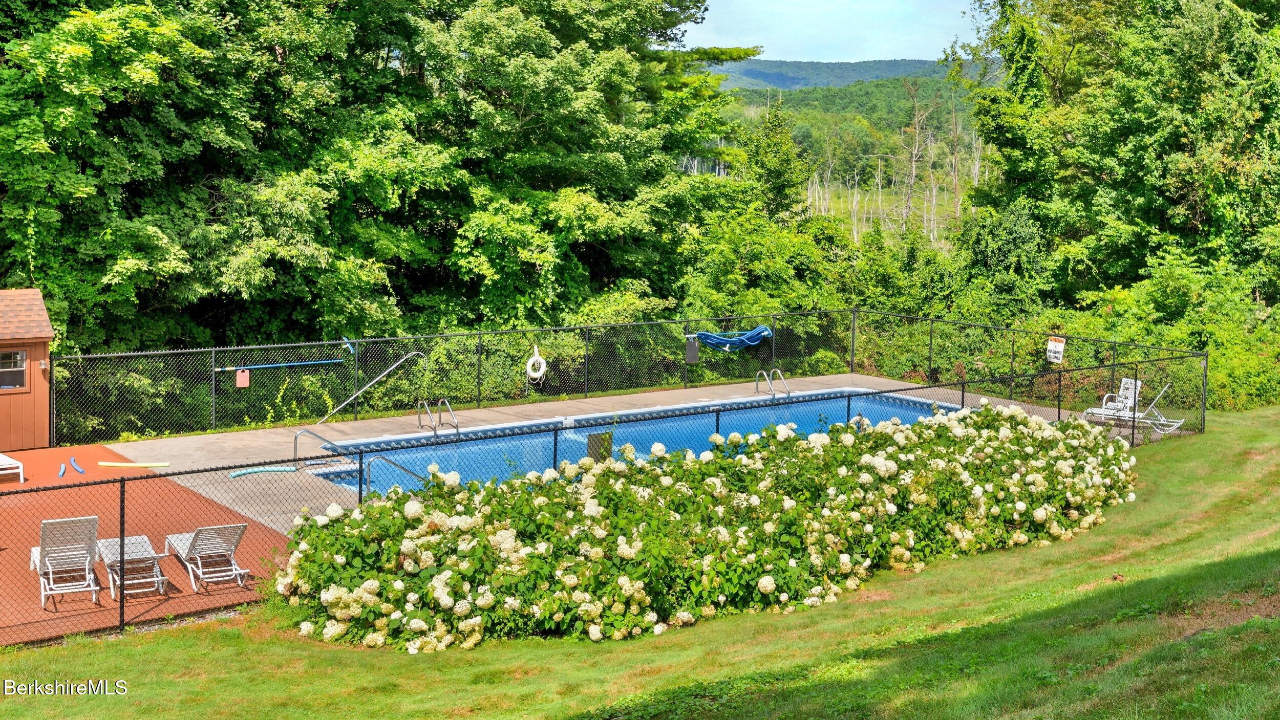 26 Churchill Crest Pittsfield, MA 01201 - Photo 16 of 16 a view of a yard with plants and a bench