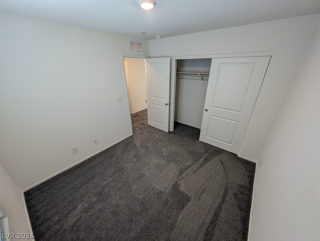 4820 Orchid Rdg Avenue Las Vegas, NV 89141 - Photo 23 of 27 A well-proportioned bedroom with new gray carpeting and a practical closet system.