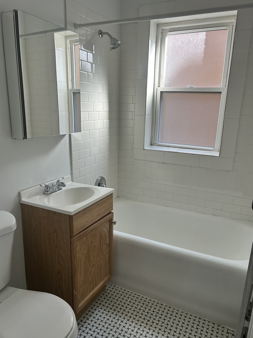 5427 West Montrose Avenue, Unit 1 Chicago, IL 60641 - Photo 13 of 13 a bathroom with a sink toilet and shower