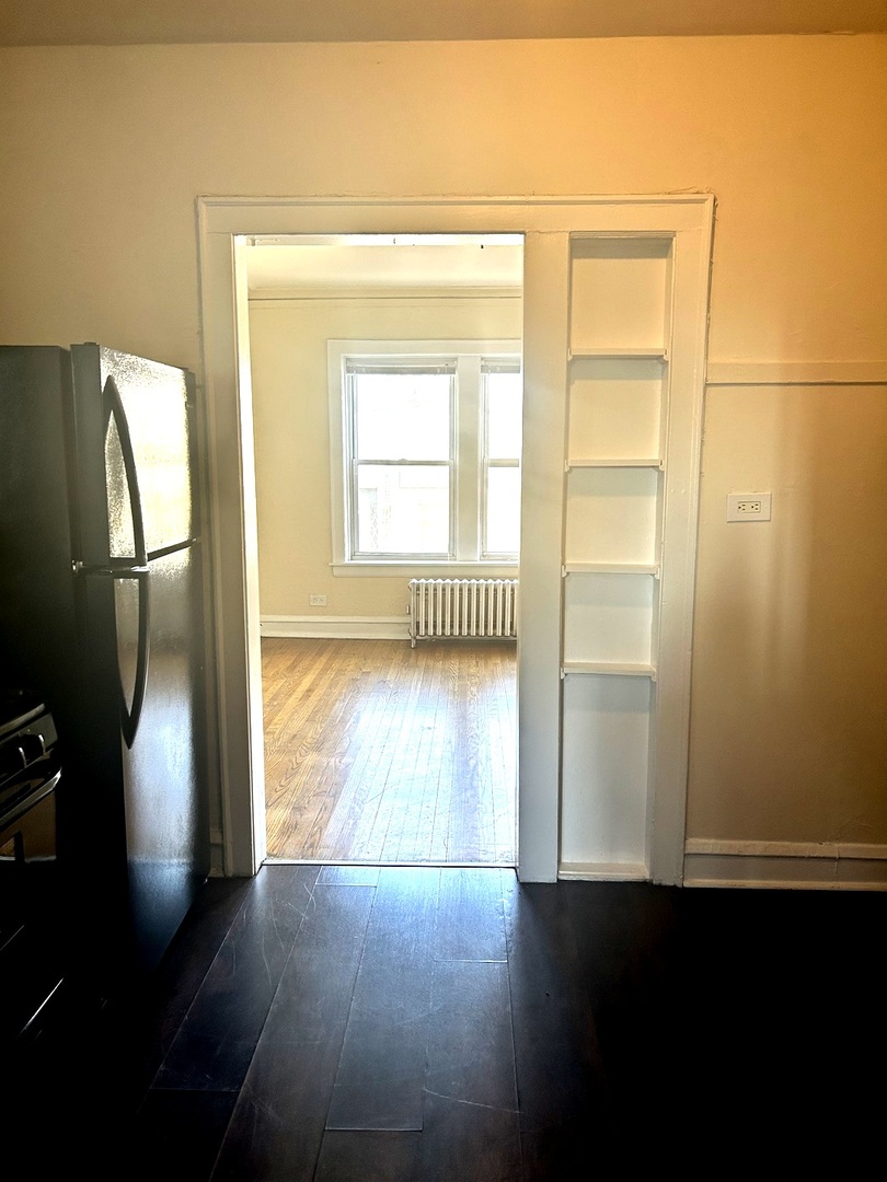 5427 West Montrose Avenue, Unit 1 Chicago, IL 60641 - Photo 4 of 13 a view of empty room with wooden floor and fan