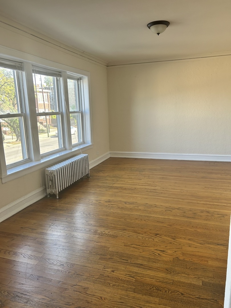 5427 West Montrose Avenue, Unit 1 Chicago, IL 60641 - Photo 7 of 13 wooden floor in an empty room with a window