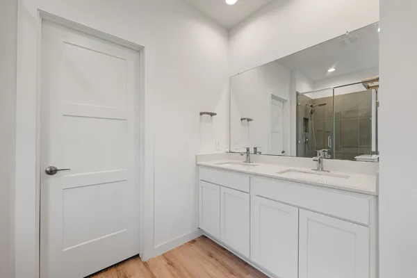 a bathroom with a double vanity sink and a mirror