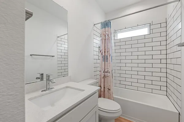 a bathroom with a sink toilet and shower