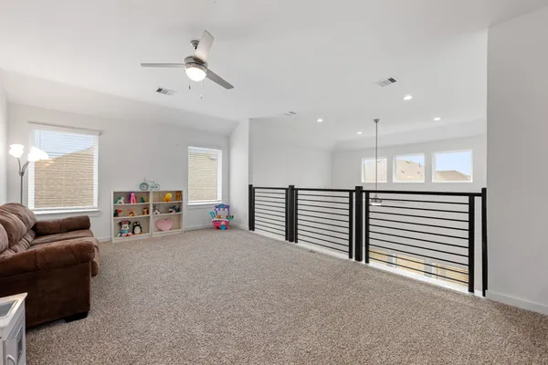 a view of a livingroom with furniture and a ceiling fan