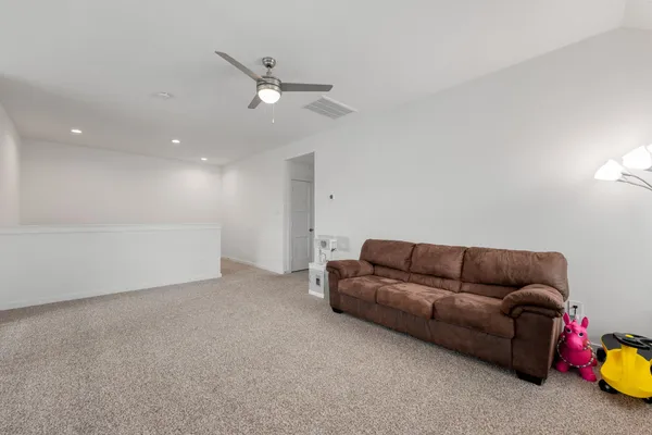 a living room with furniture and kitchen view