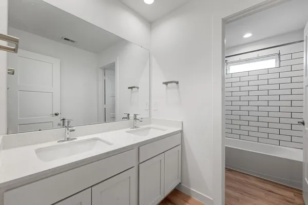 a bathroom with a sink double vanity and shower