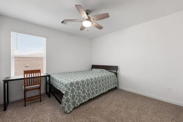 a bedroom with a bed and a window