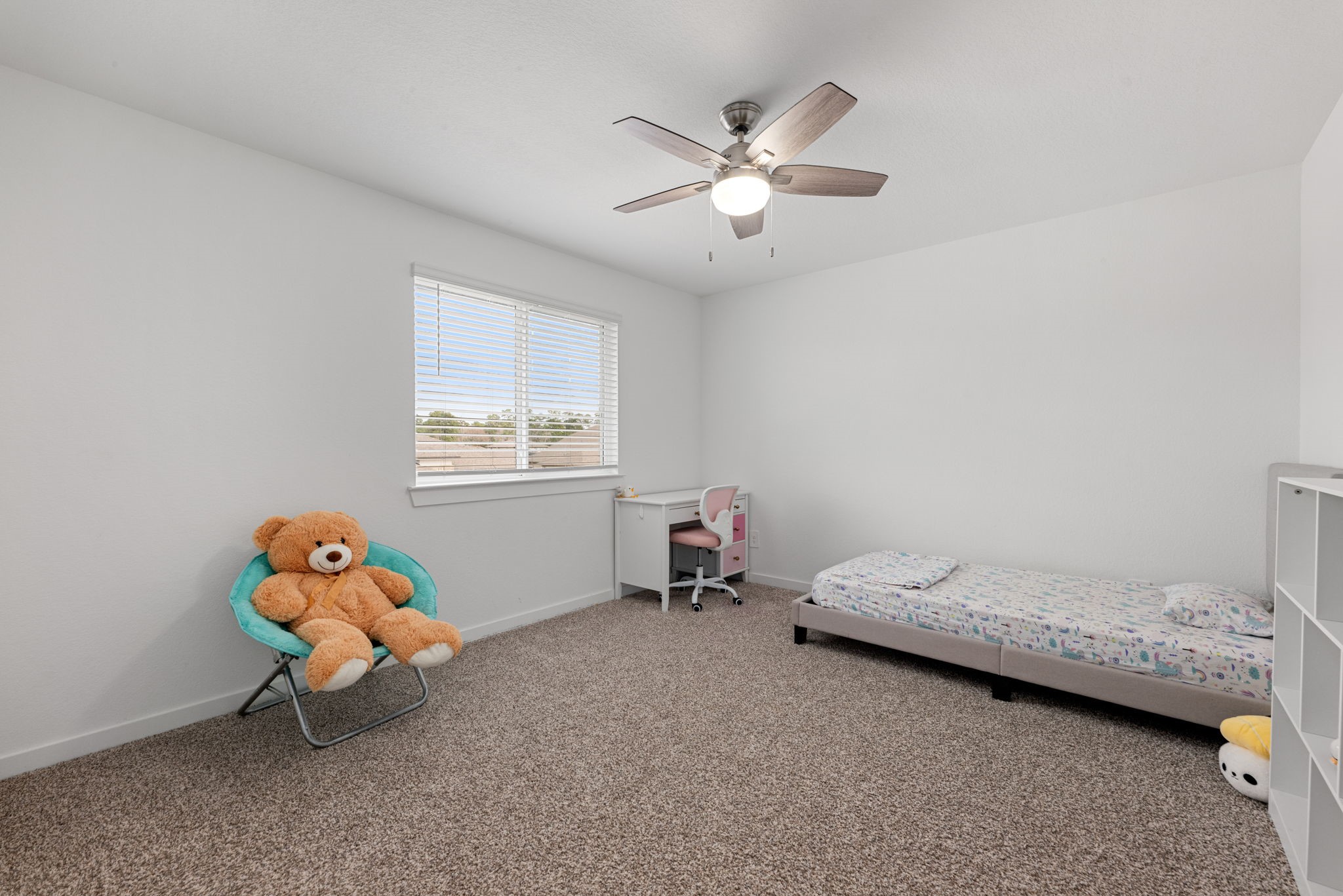 14019 Valley Creek Conroe, TX 77384 - Photo 21 of 30 a bedroom with a bed and a chandelier