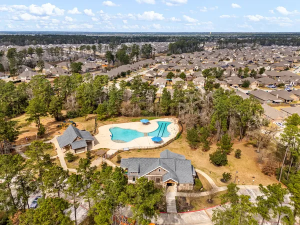 an aerial view of residential houses with outdoor space