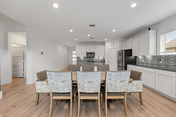 a view of a dining room with furniture and wooden floor