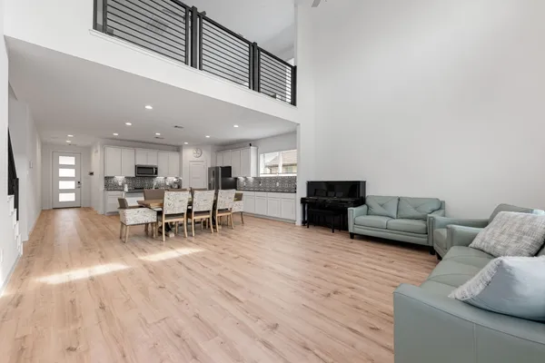 a living room with furniture and a wooden floor
