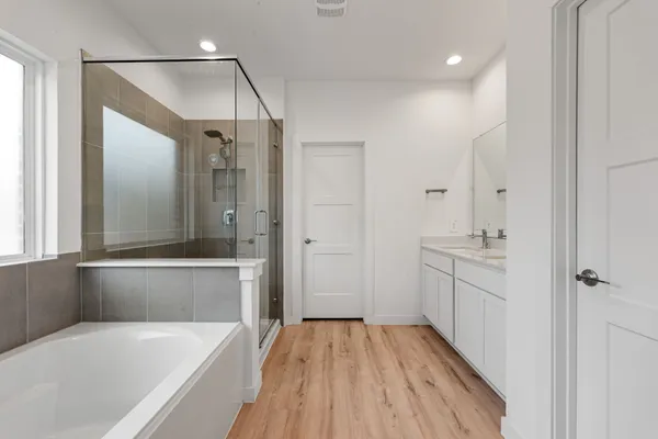 a bathroom with a bathtub and a shower