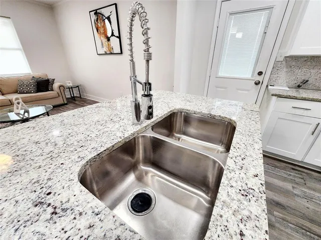 a kitchen with a sink and a stove