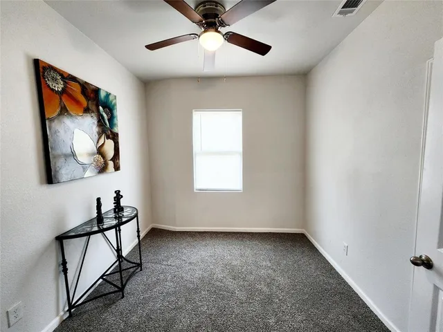 a view of room with window and ceiling fan