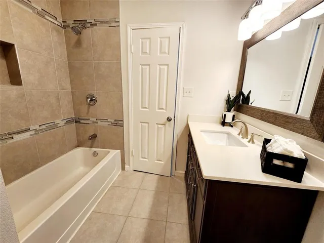 a bathroom with a sink a mirror and a bathtub