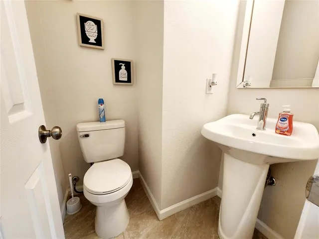 a white toilet sitting next to a bathroom sink