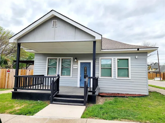 a view of a house with a yard and deck