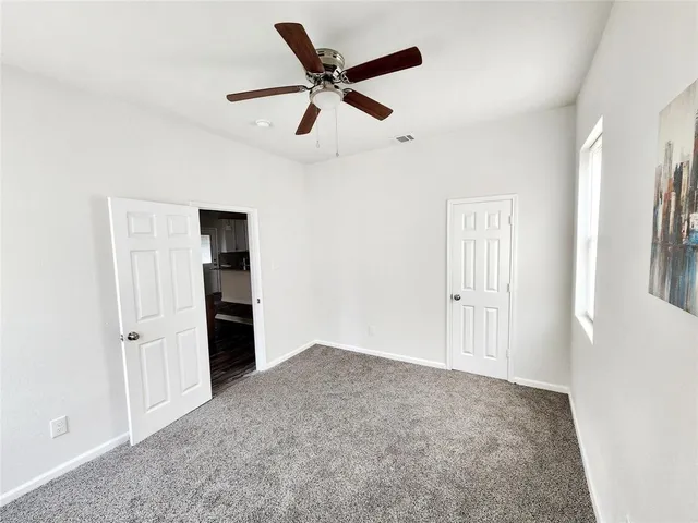 a view of empty room with ceiling fan