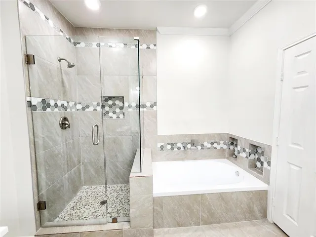 a bathroom with a bathtub and shower
