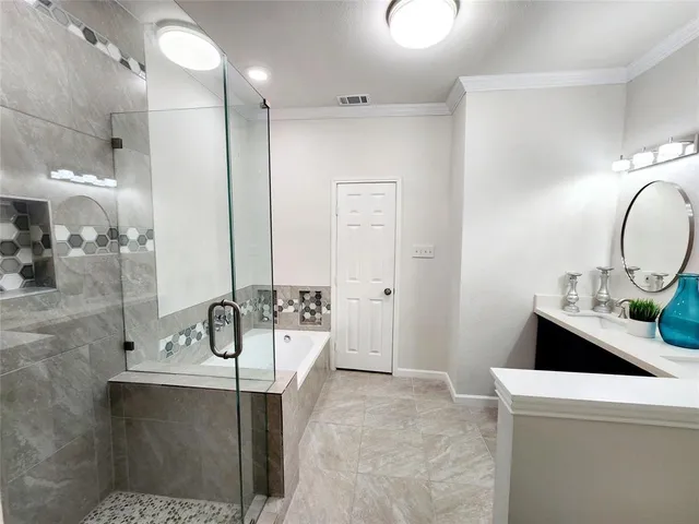 a bathroom with a tub sink and mirror