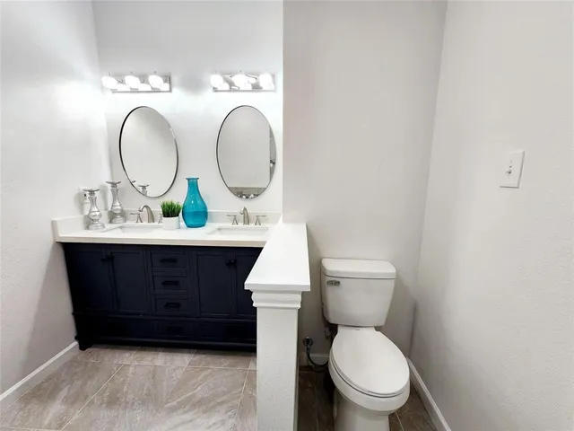 a bathroom with a toilet a sink and a mirror