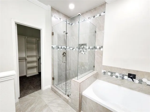 a bathroom with a tub sink vanity and a mirror