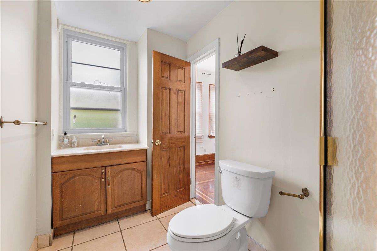 345 Broadway Lawrence, NY 11559 - Photo 13 of 25 a bathroom with a toilet a sink and shower
