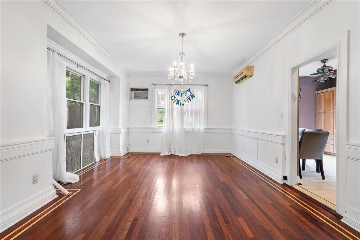 345 Broadway Lawrence, NY 11559 - Photo 14 of 25 wooden floor in an empty room with a window