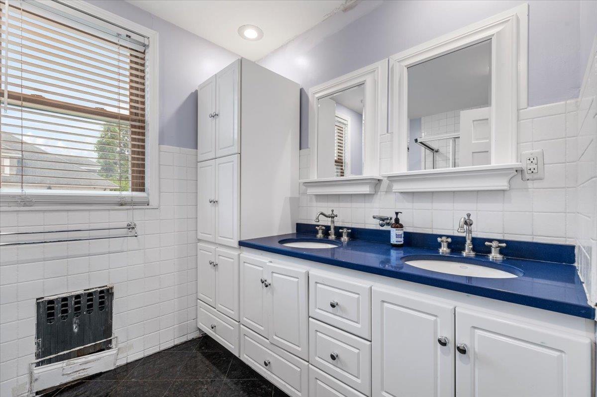 345 Broadway Lawrence, NY 11559 - Photo 16 of 25 a kitchen with white cabinets and sink