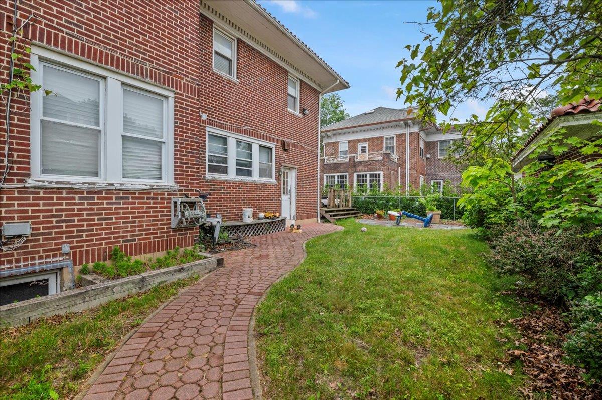 345 Broadway Lawrence, NY 11559 - Photo 19 of 25 a front view of a house with garden
