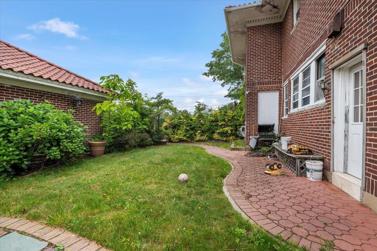 345 Broadway Lawrence, NY 11559 - Photo 20 of 25 a backyard of a house with outdoor seating